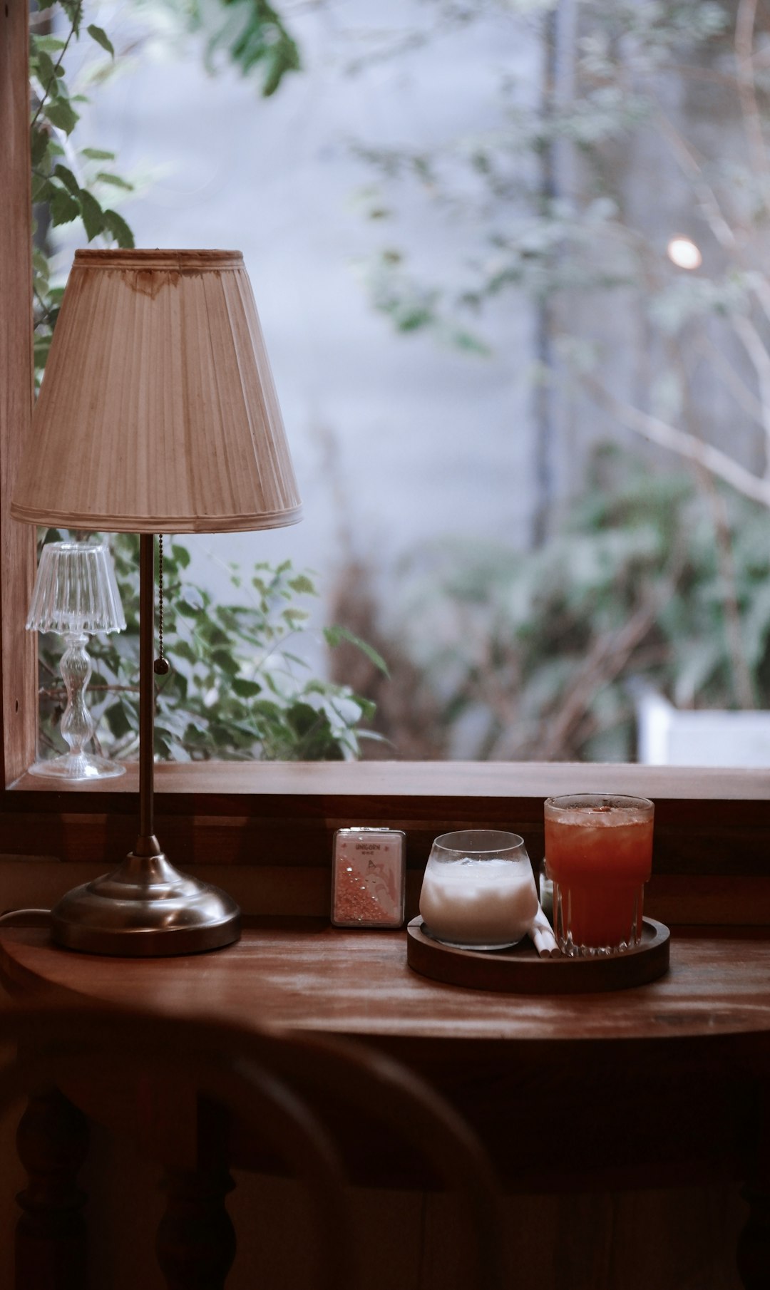 a table with a lamp and some drinks on it a table with a lamp and some drinks on it
